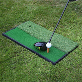 Golf practice mat with golf club and ball on grass